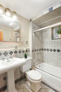 a bathroom with a sink toilet a mirror and shower