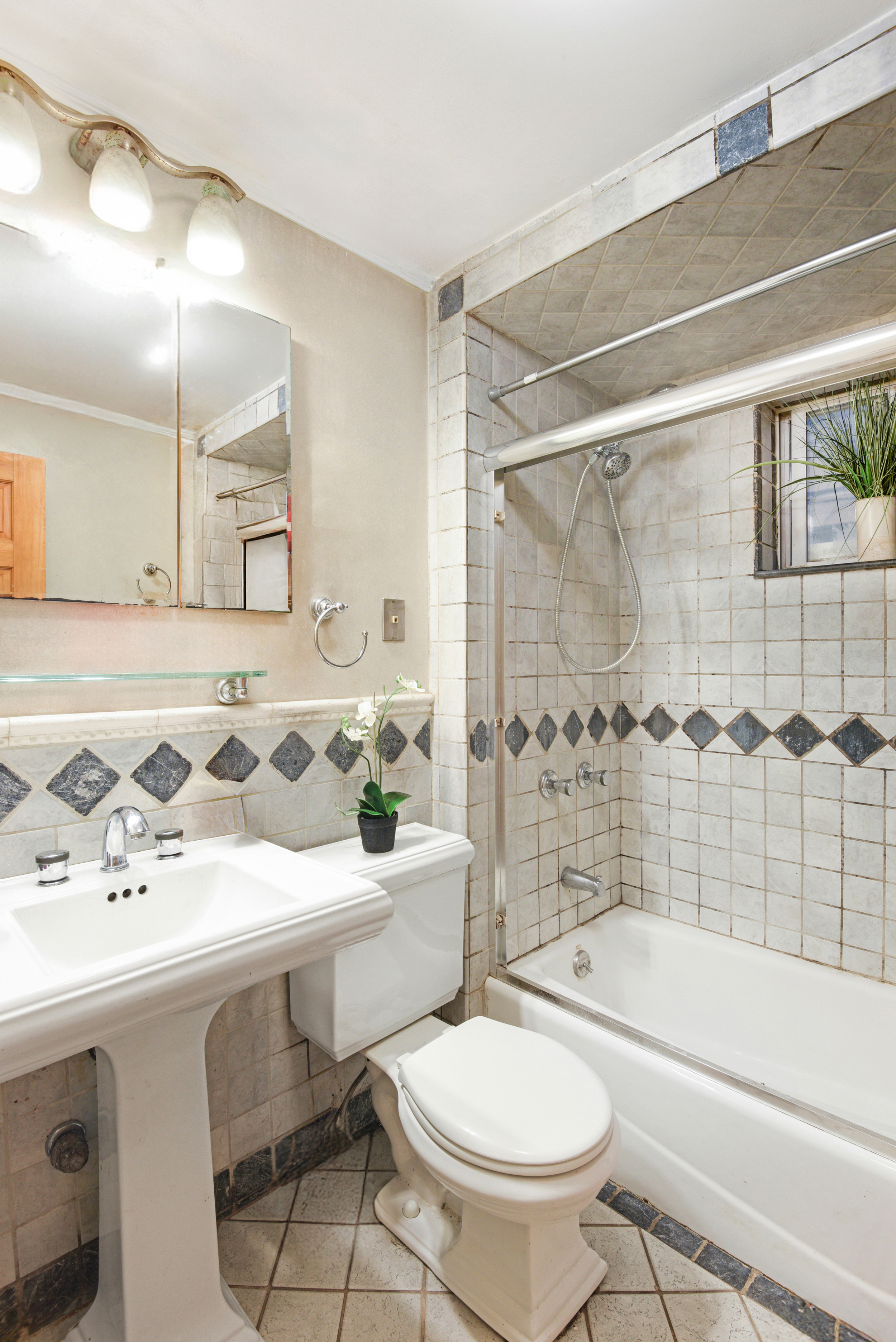 233 Battery Avenue Brooklyn, NY 11209 - Photo 10 of 17 a bathroom with a sink toilet a mirror and shower