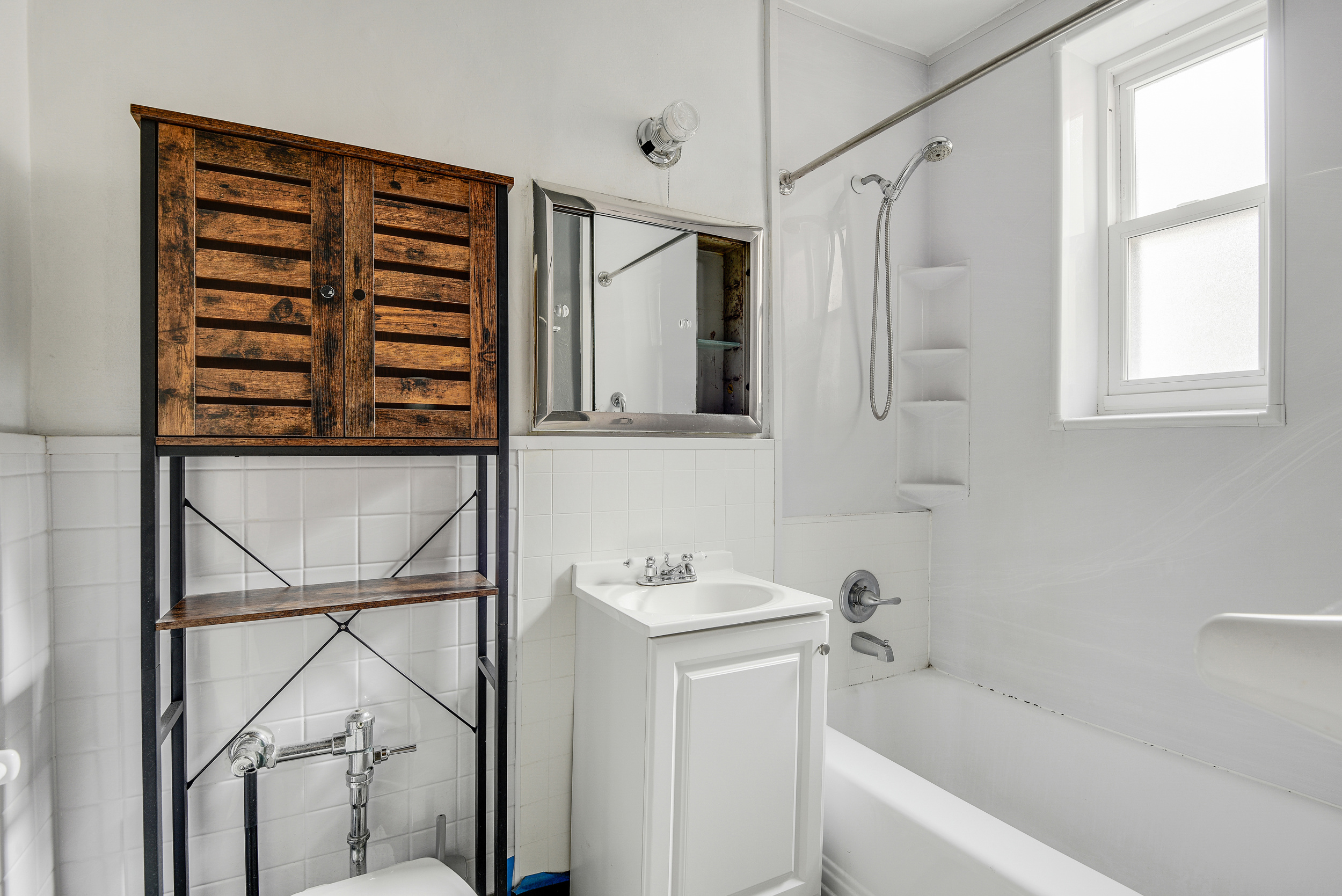 9801 Shore Road, Unit 4P Brooklyn, NY 11209 - Photo 7 of 13 a bathroom with a bathtub a shower and a window