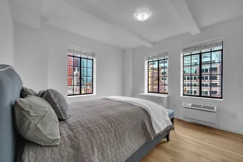 a bedroom with a bed and window