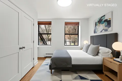 a bedroom with a large bed and a window