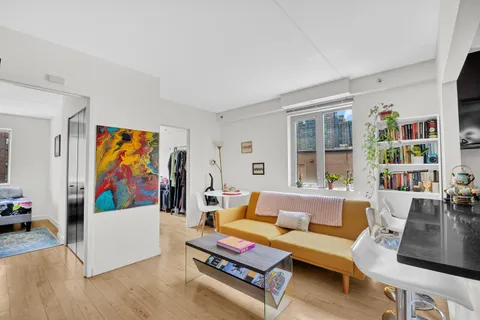 a living room with furniture and a bookshelf