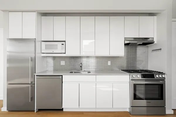 a view of a room with wooden floor and a window