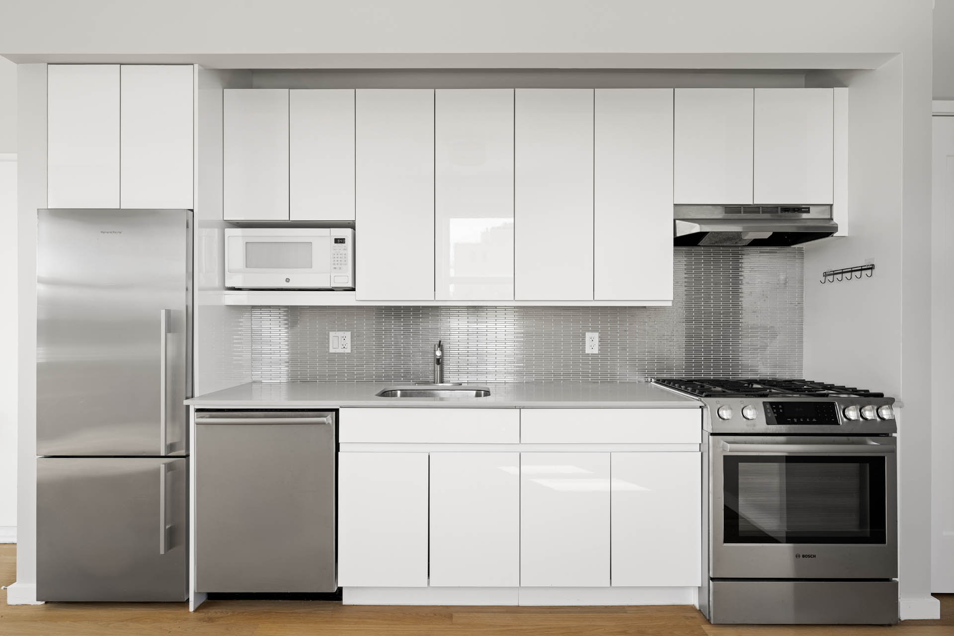 195 Hawthorne Street, Unit 5E Brooklyn, NY 11225 - Photo 8 of 23 a kitchen with granite countertop white cabinets and stainless steel appliances