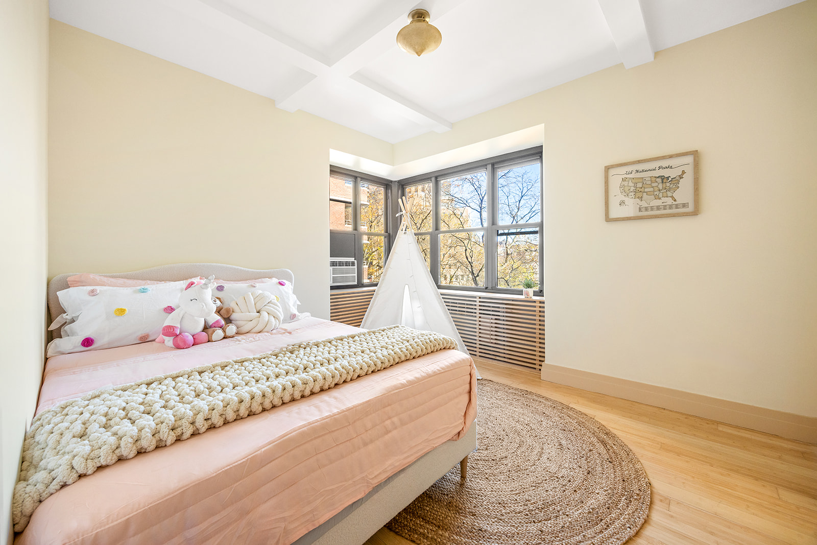 208 East Broadway, Unit J405/J406 Manhattan, NY 10002 - Photo 9 of 21 a bedroom with a bed and a window