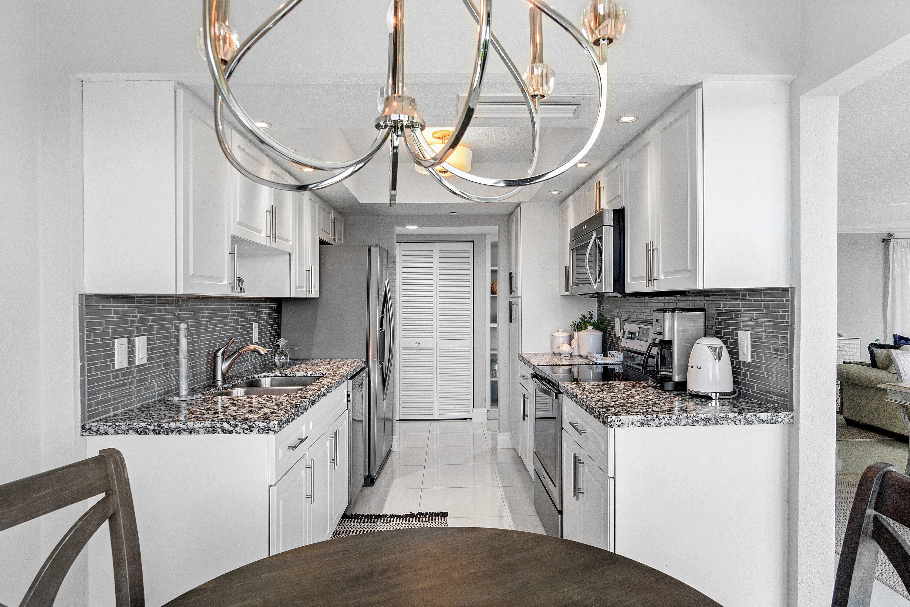 2003 North Ocean Boulevard, Unit 305 Boca Raton, FL 33431 - Photo 35 of 56 a kitchen that has a lot of cabinets in it