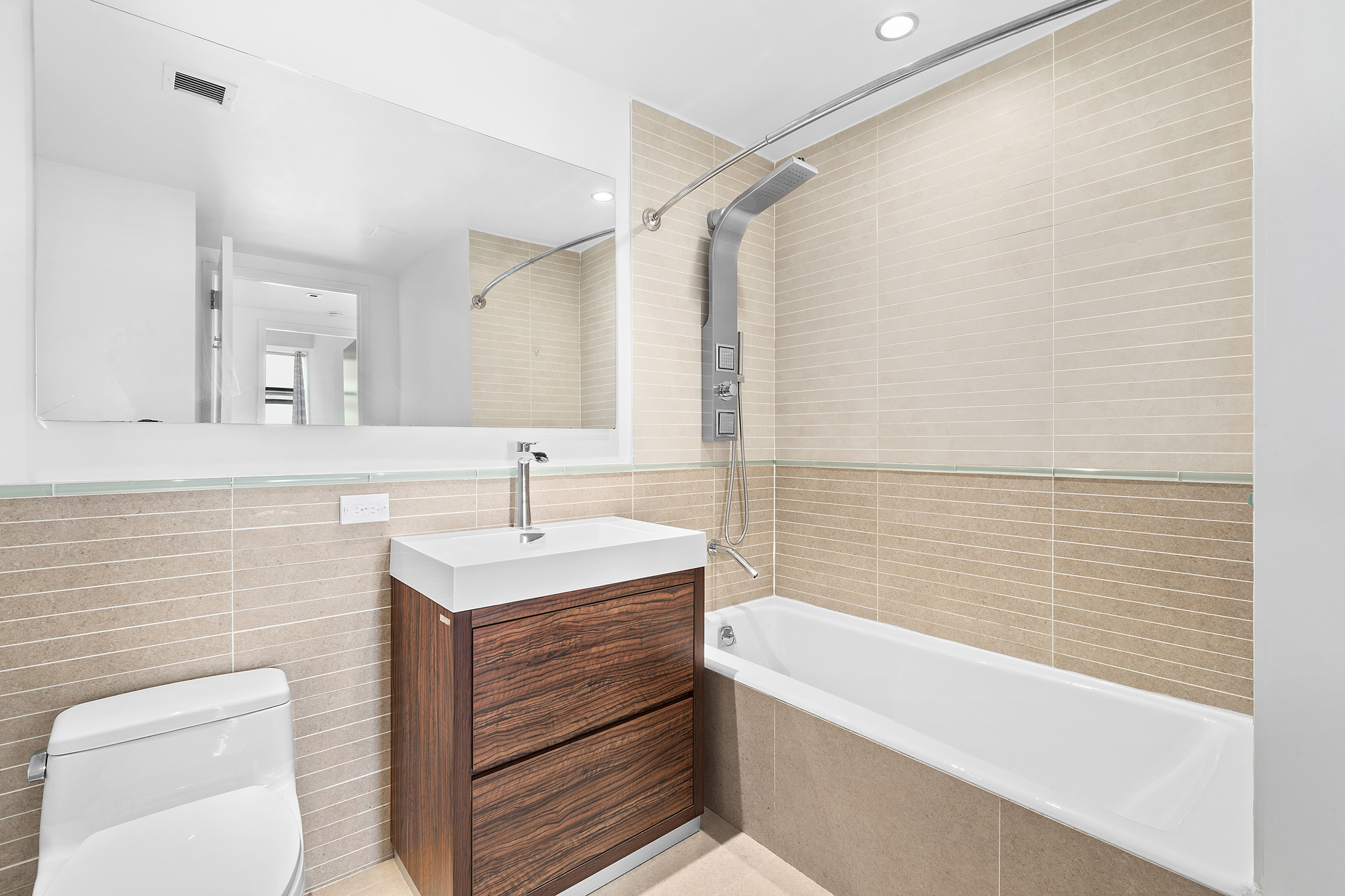 2-17 51st Avenue, Unit 913 Queens, NY 11101 - Photo 8 of 17 a bathroom with a sink and a bathtub