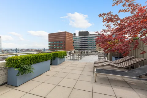 a view of a building with garden and sitting area