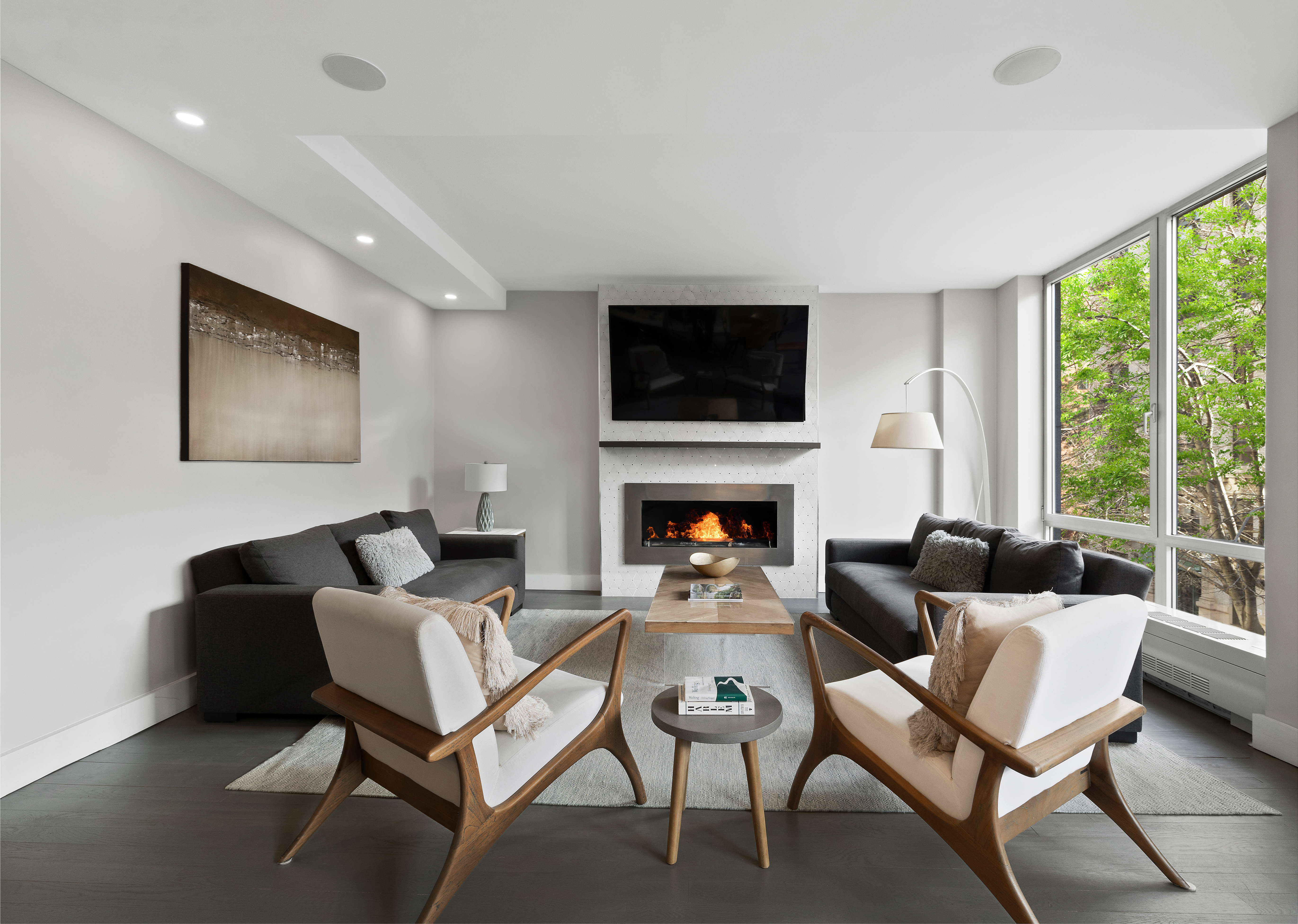 129 West 123rd Street, Unit 3 Manhattan, NY 10027 - Photo 4 of 20 a living room with furniture a flat screen tv and a fireplace