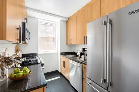 a kitchen with sink refrigerator and window