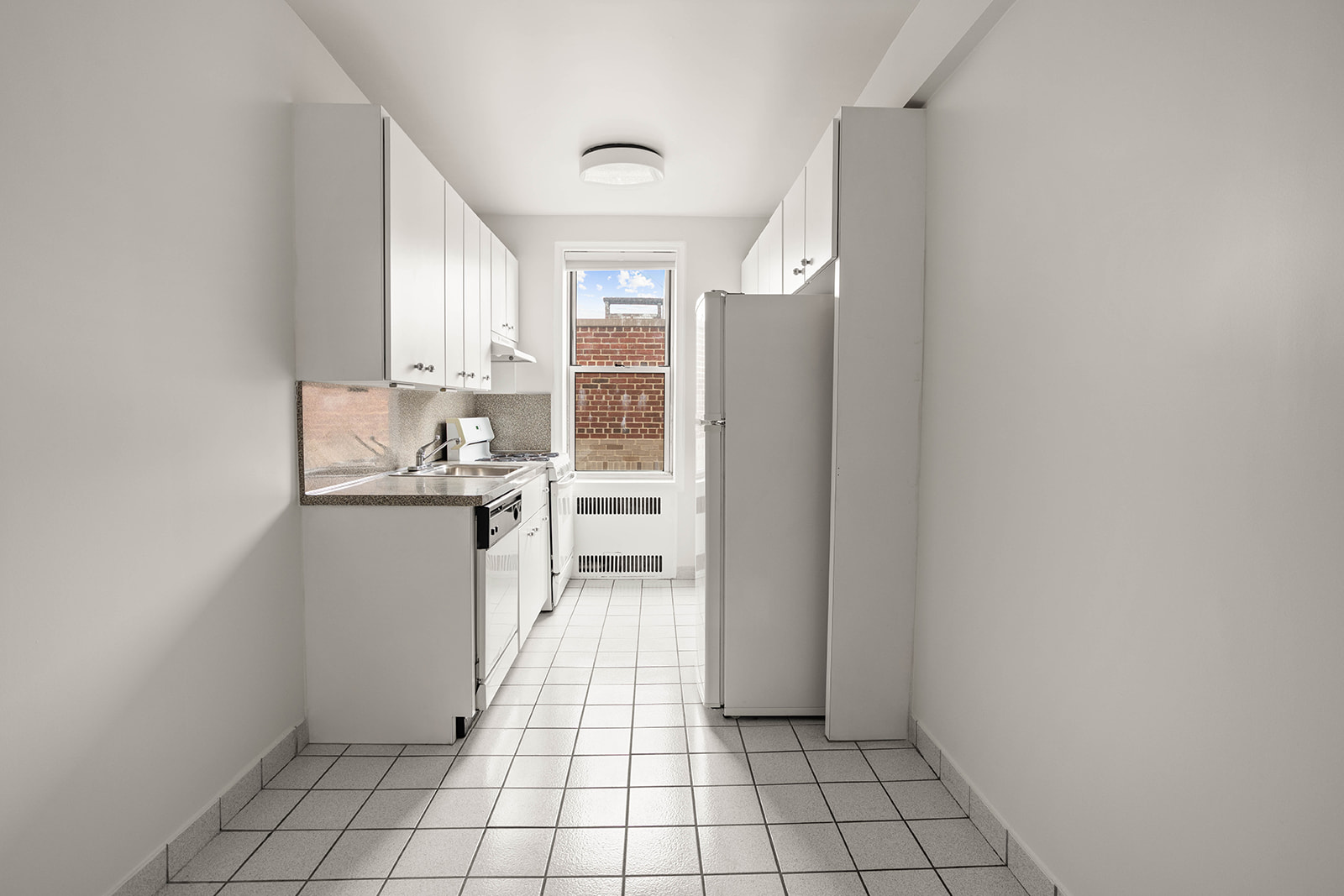 76-12 35th Avenue, Unit 6J Queens, NY 11372 - Photo 10 of 17 a view of kitchen with windows