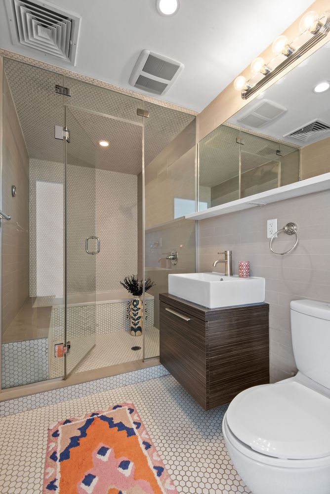 179 Woodpoint Road, Unit 4A Brooklyn, NY 11211 - Photo 7 of 16 a bathroom with a sink a toilet and shower