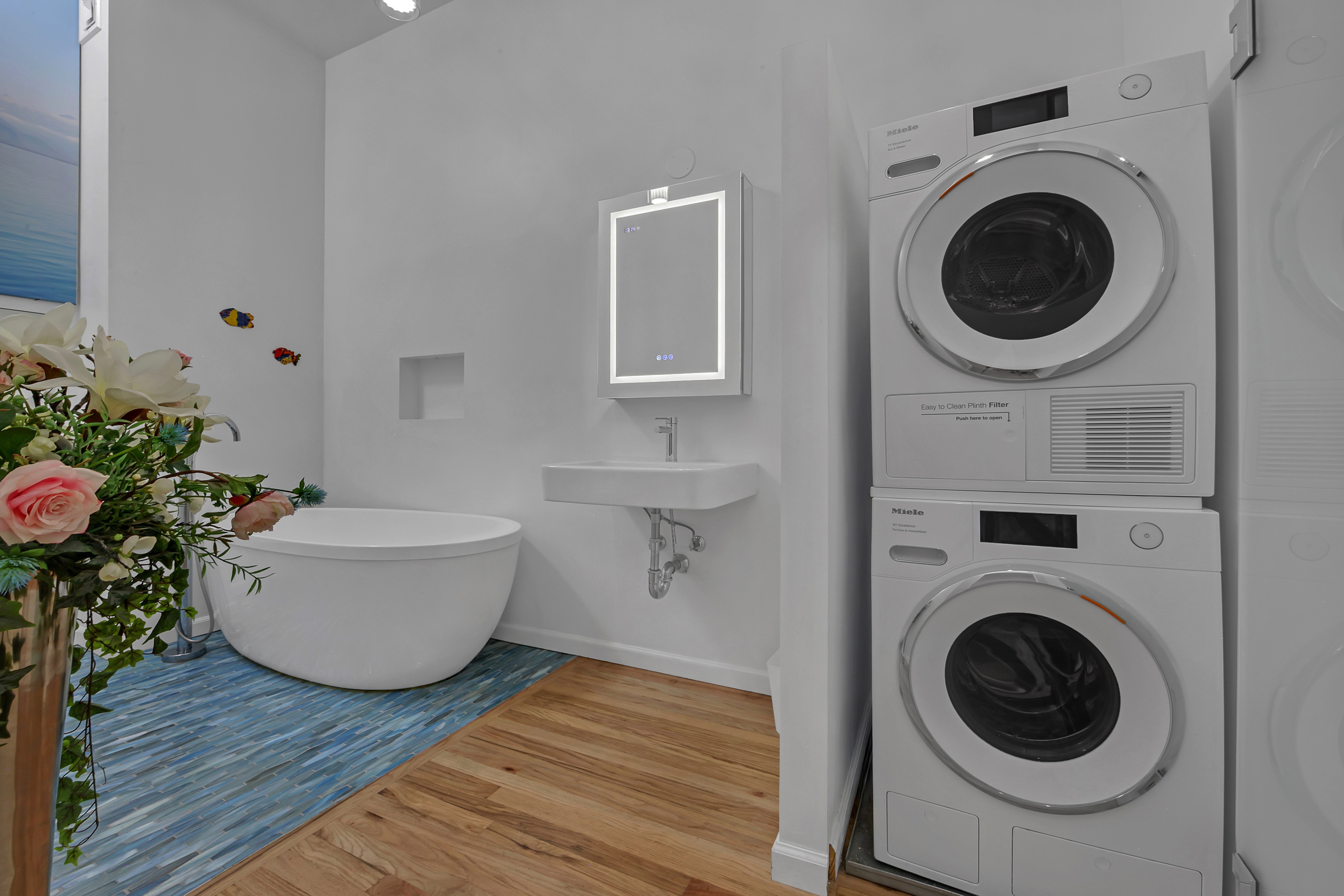 56 East 11th Street, Unit 7 Manhattan, NY 10003 - Photo 10 of 18 a living room with furniture and a mirror