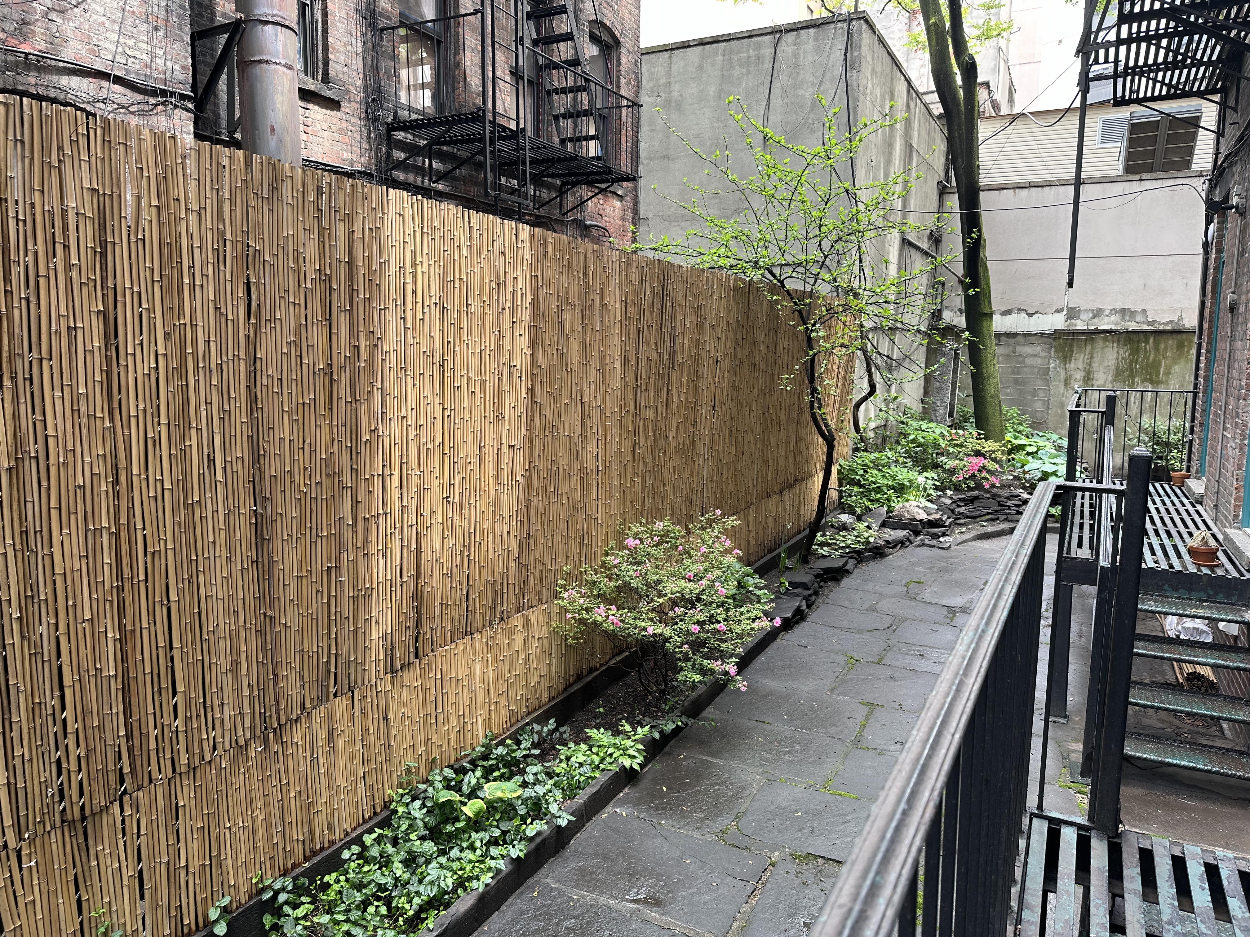 459 West 35th Street, Unit 1E Manhattan, NY 10001 - Photo 16 of 18 a view of a pathway along with wooden fence