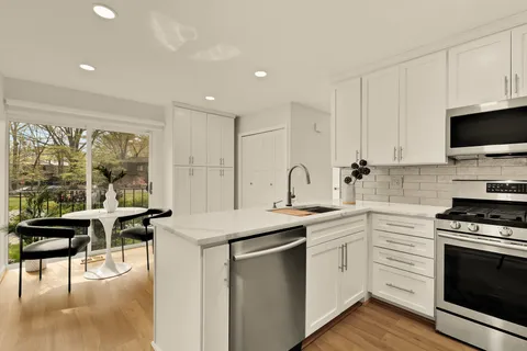 a kitchen with a sink stove and cabinets