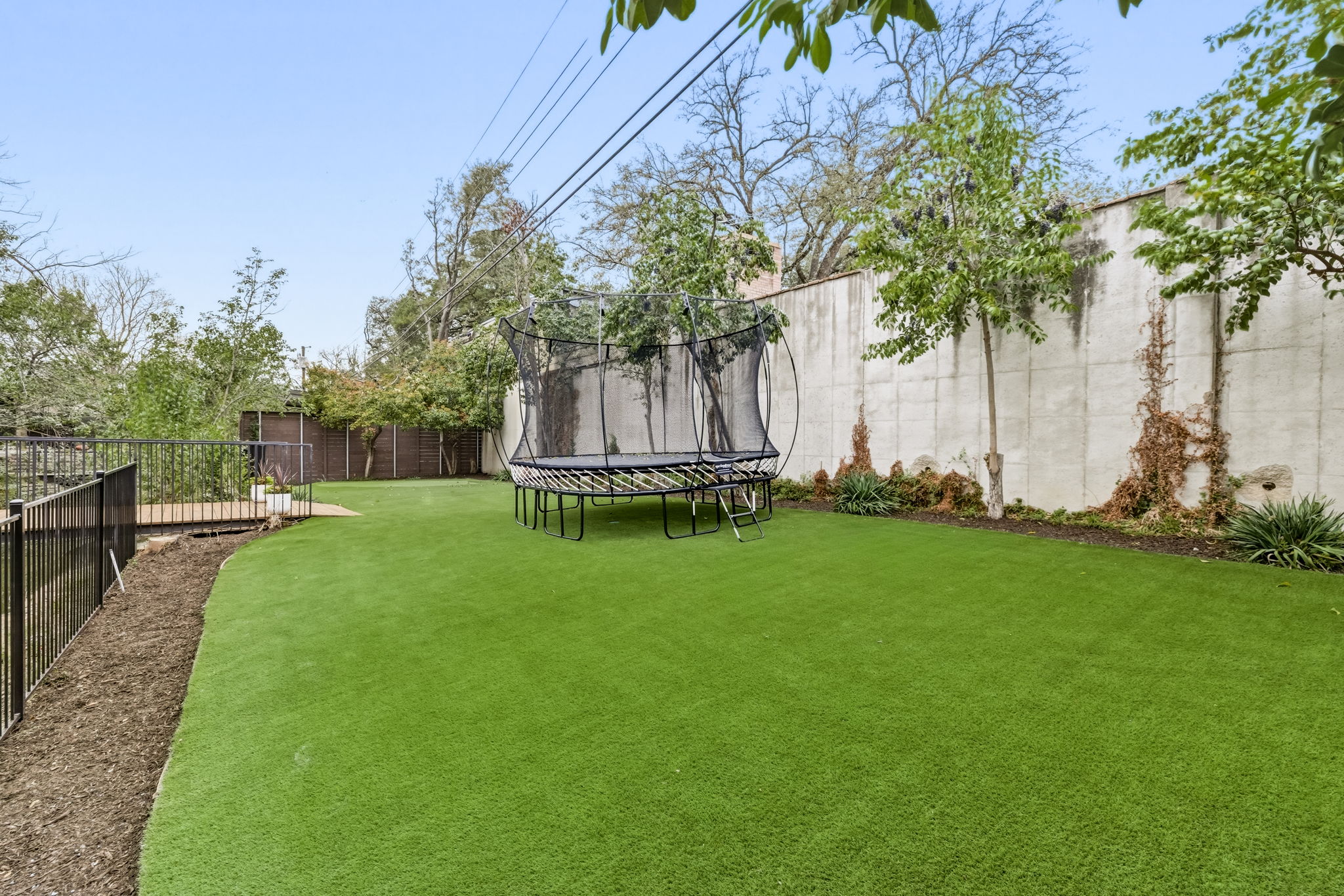5765 Stonegate Road Dallas, TX 75209 - Photo 34 of 37 a view of a backyard with a garden