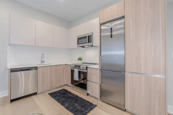 a kitchen with cabinets and stainless steel appliances