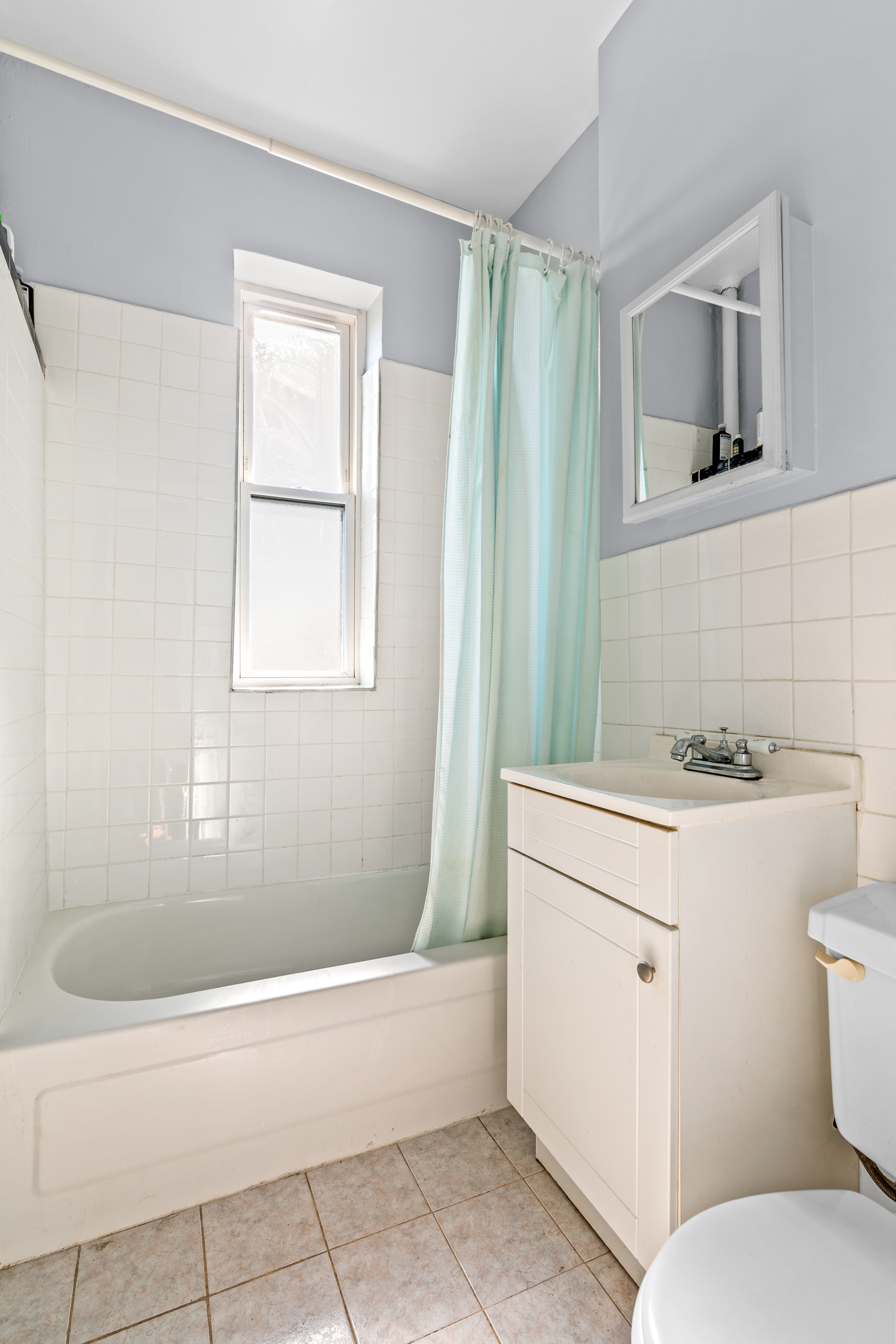 374 South 2nd Street, Unit 33 Brooklyn, NY 11211 - Photo 7 of 8 a bathroom with a sink toilet vanity and tub