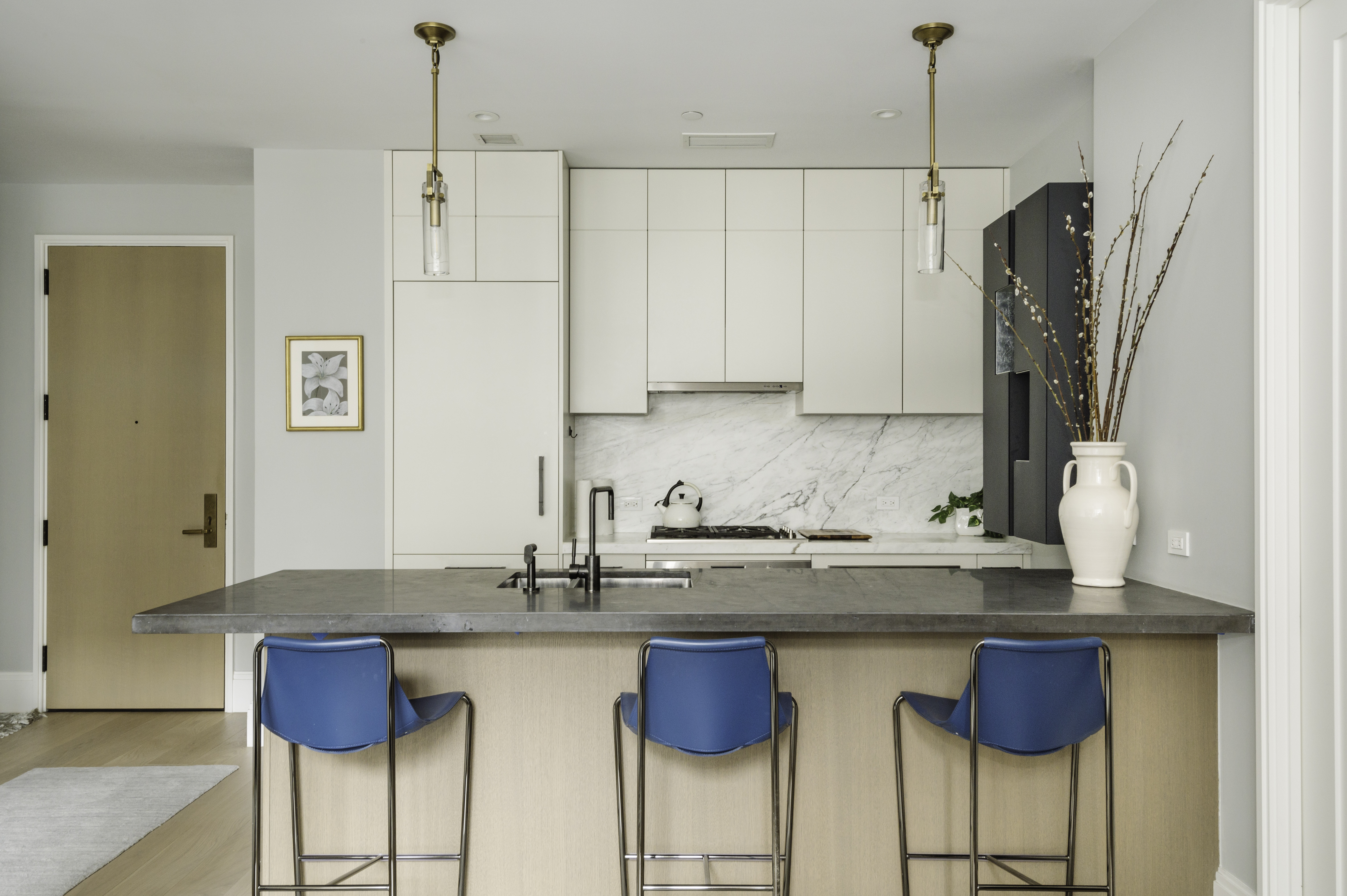 a kitchen with stainless steel appliances granite countertop a white cabinets and a refrigerator