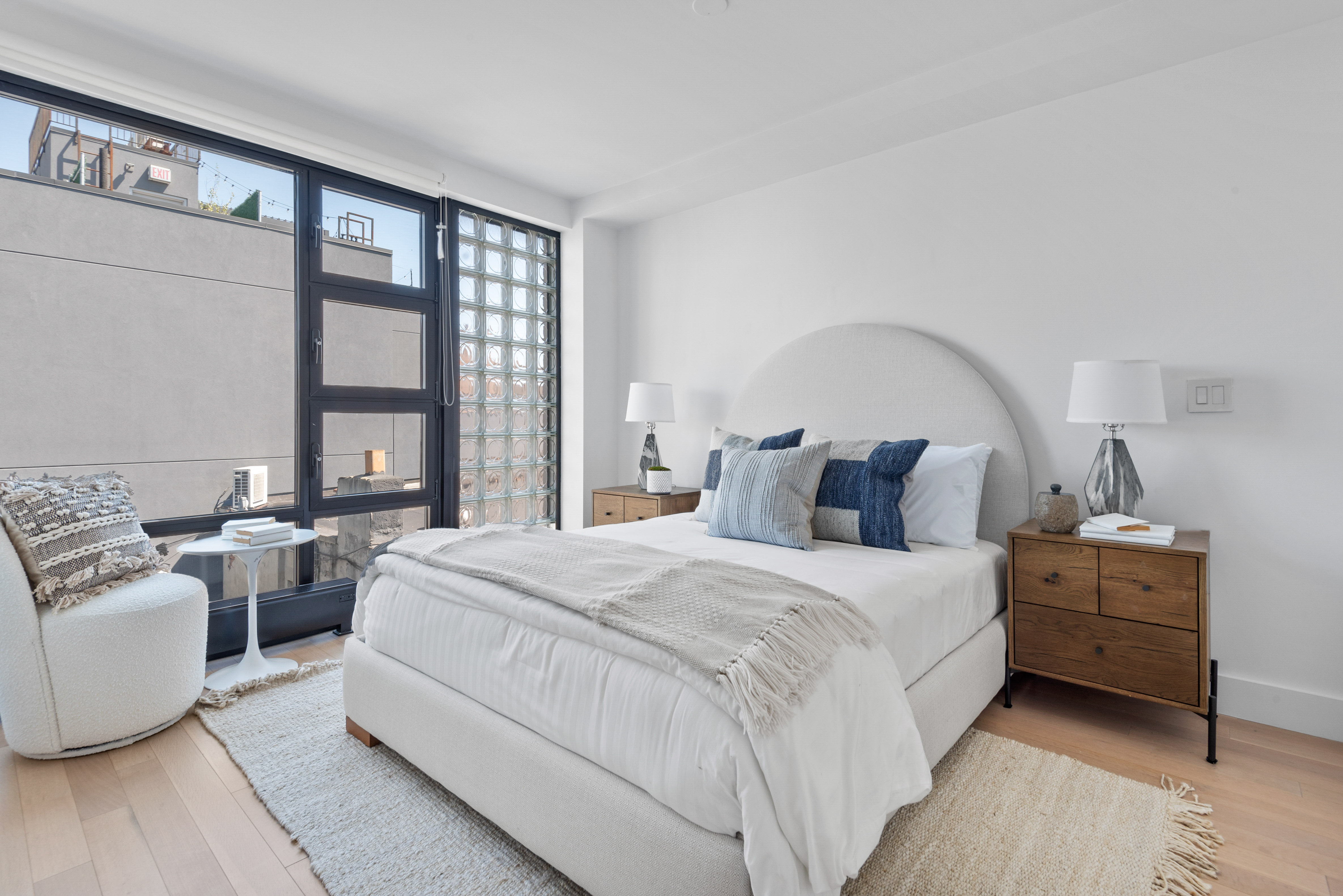 476 Union Avenue, Unit PH5A Brooklyn, NY 11211 - Photo 11 of 17 a bedroom with bed and large window