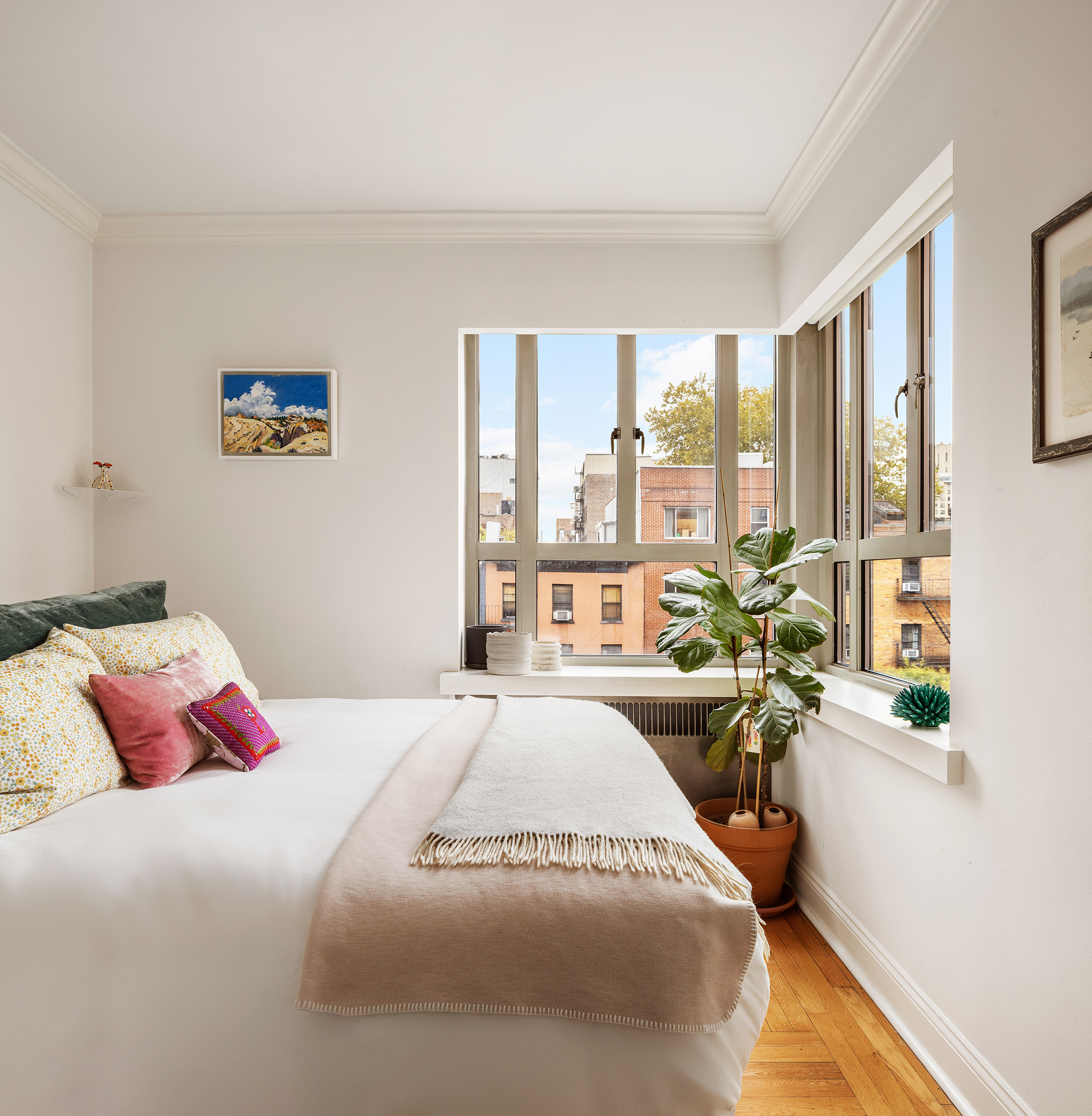 165 West 20th Street, Unit 4K Manhattan, NY 10011 - Photo 4 of 7 a bedroom with a bed couch and a large window