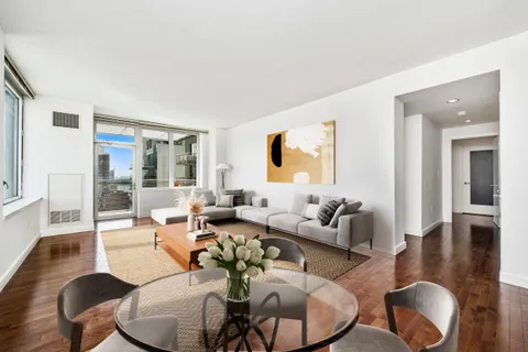 a living room with furniture or couch and a wooden floor
