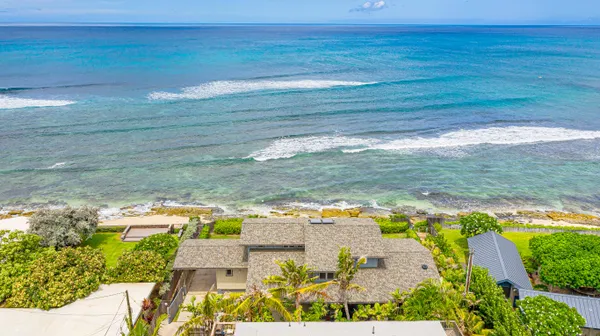 an aerial view of a house with balcony and garden
