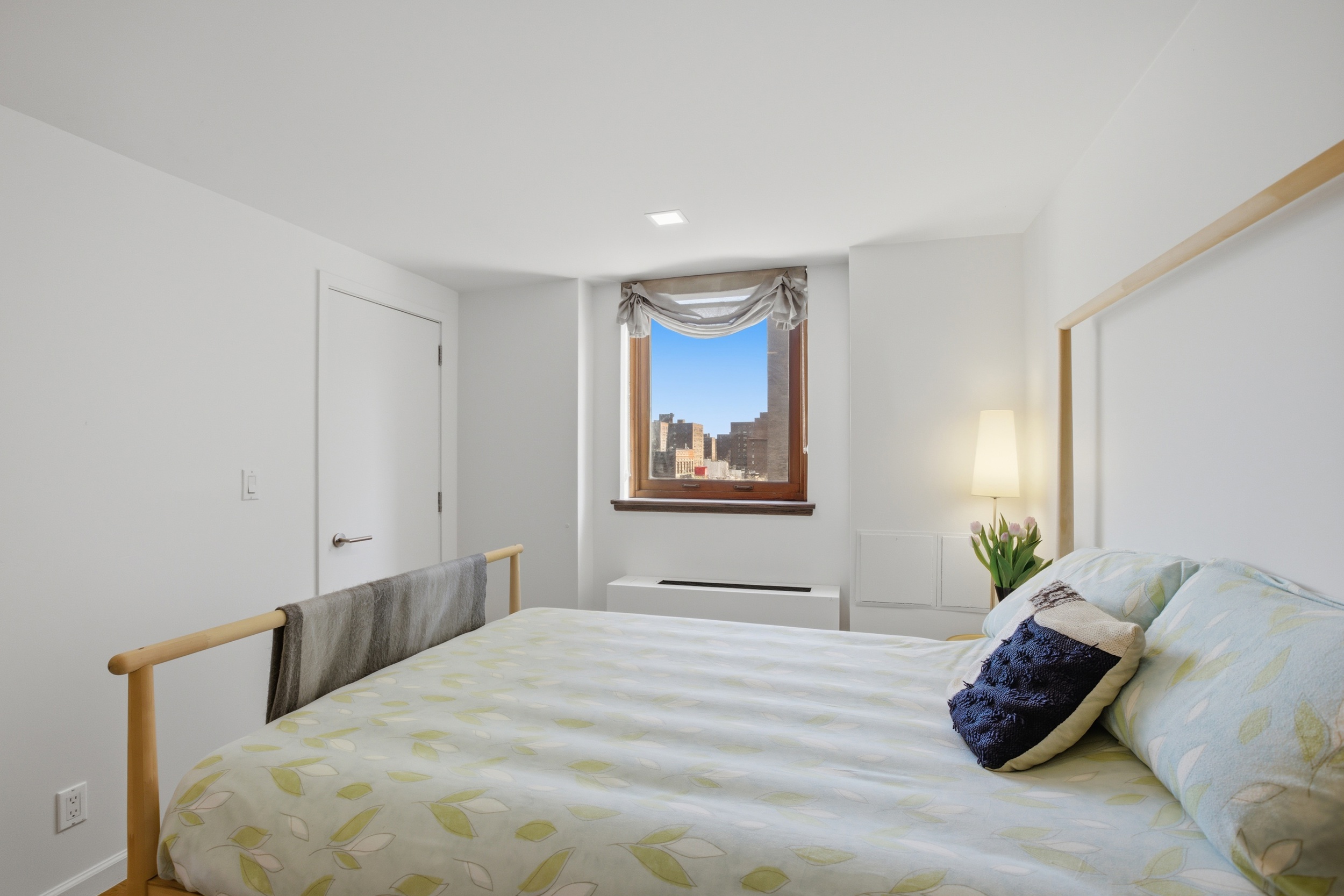 305 2nd Avenue, Unit 521 Manhattan, NY 10003 - Photo 10 of 20 a bedroom with a bed and a painting on the wall