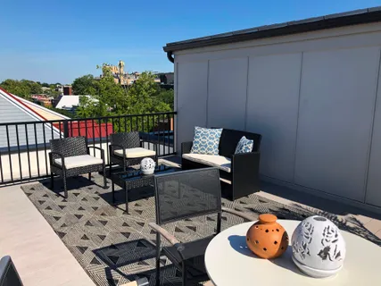 a balcony with furniture and a potted plant