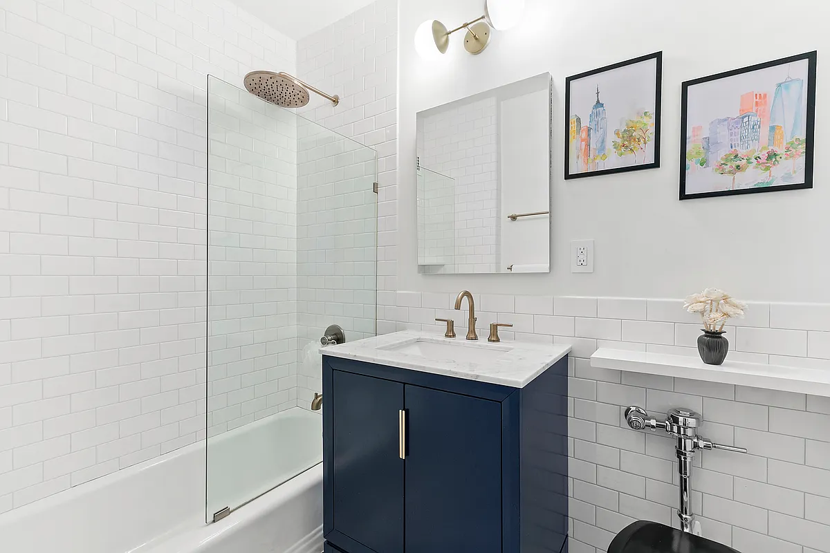 99 Bank Street, Unit 50 Manhattan, NY 10014 - Photo 3 of 7 a bathroom with a sink and a mirror