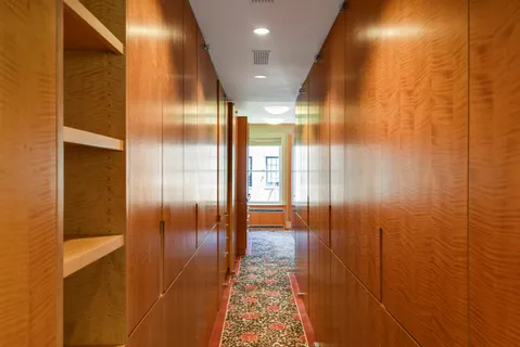 a view of hallway with a bathroom