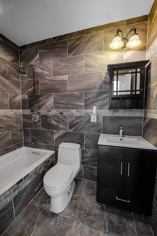 877 Greene Avenue, Unit 2 Brooklyn, NY 11221 - Photo 9 of 13 a bathroom with a sink toilet and shower