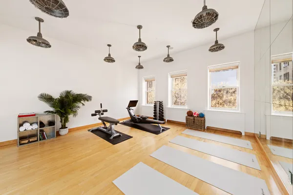 a living room with furniture windows and a chandelier
