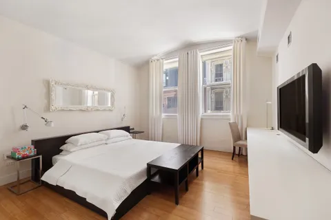 a bathroom with a double vanity sink toilet mirror and shower