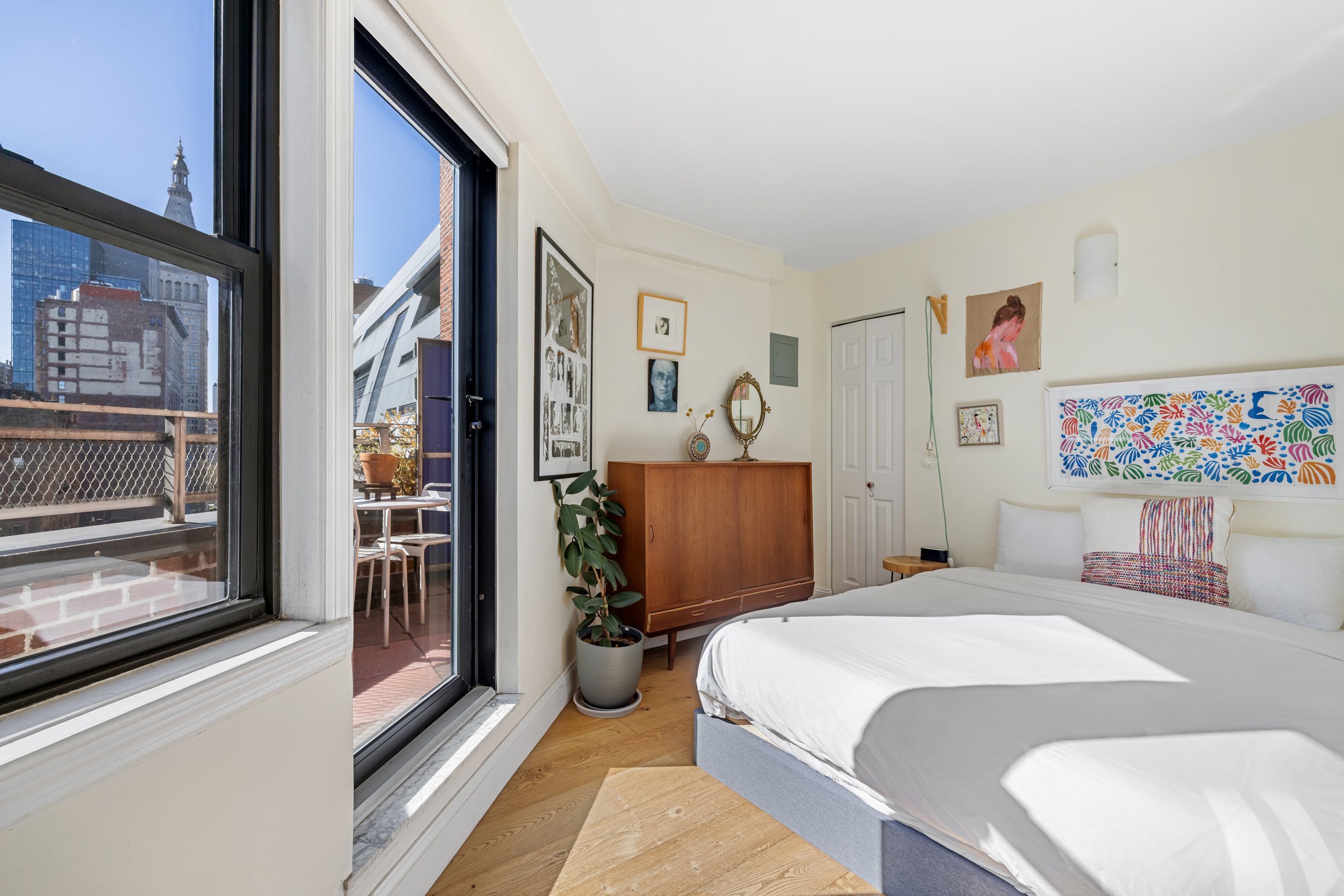 330 3rd Avenue, Unit 18F Manhattan, NY 10010 - Photo 3 of 10 a bedroom with a large bed and a chandelier