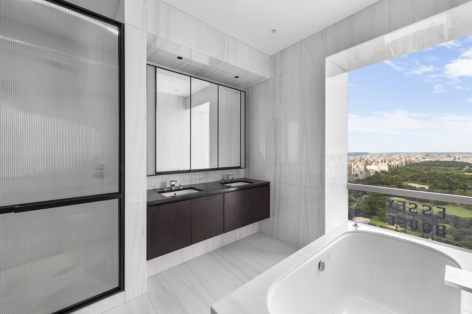 157 West 57th Street, Unit 56C Manhattan, NY 10019 - Photo 8 of 12 a bathroom with a granite countertop sink and a large mirror