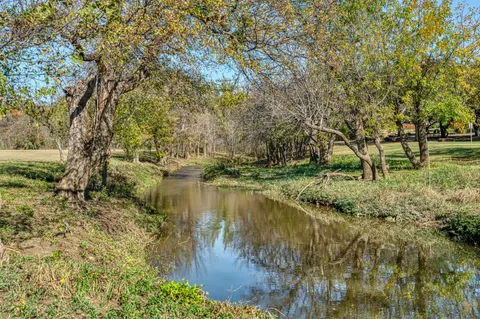a view of a swimming pool with a yard