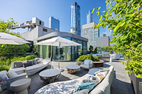a view of a patio with couches under an umbrella