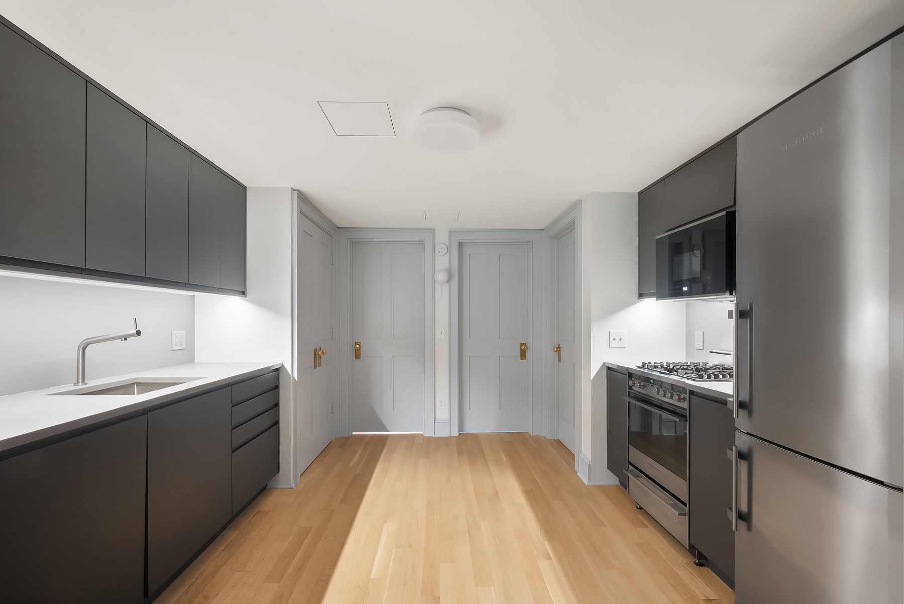 142 6th Avenue, Unit 1 Brooklyn, NY 11217 - Photo 3 of 14 a kitchen with a sink stove and cabinets