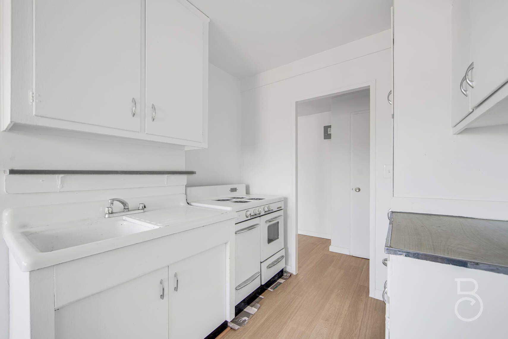 33-65 14th Street, Unit 5D Queens, NY 11106 - Photo 5 of 11 a utility room with cabinets washer and dryer