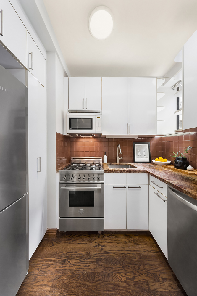 353 West 56th Street, Unit 2G Manhattan, NY 10019 - Photo 3 of 13 a kitchen with a stove top oven and sink