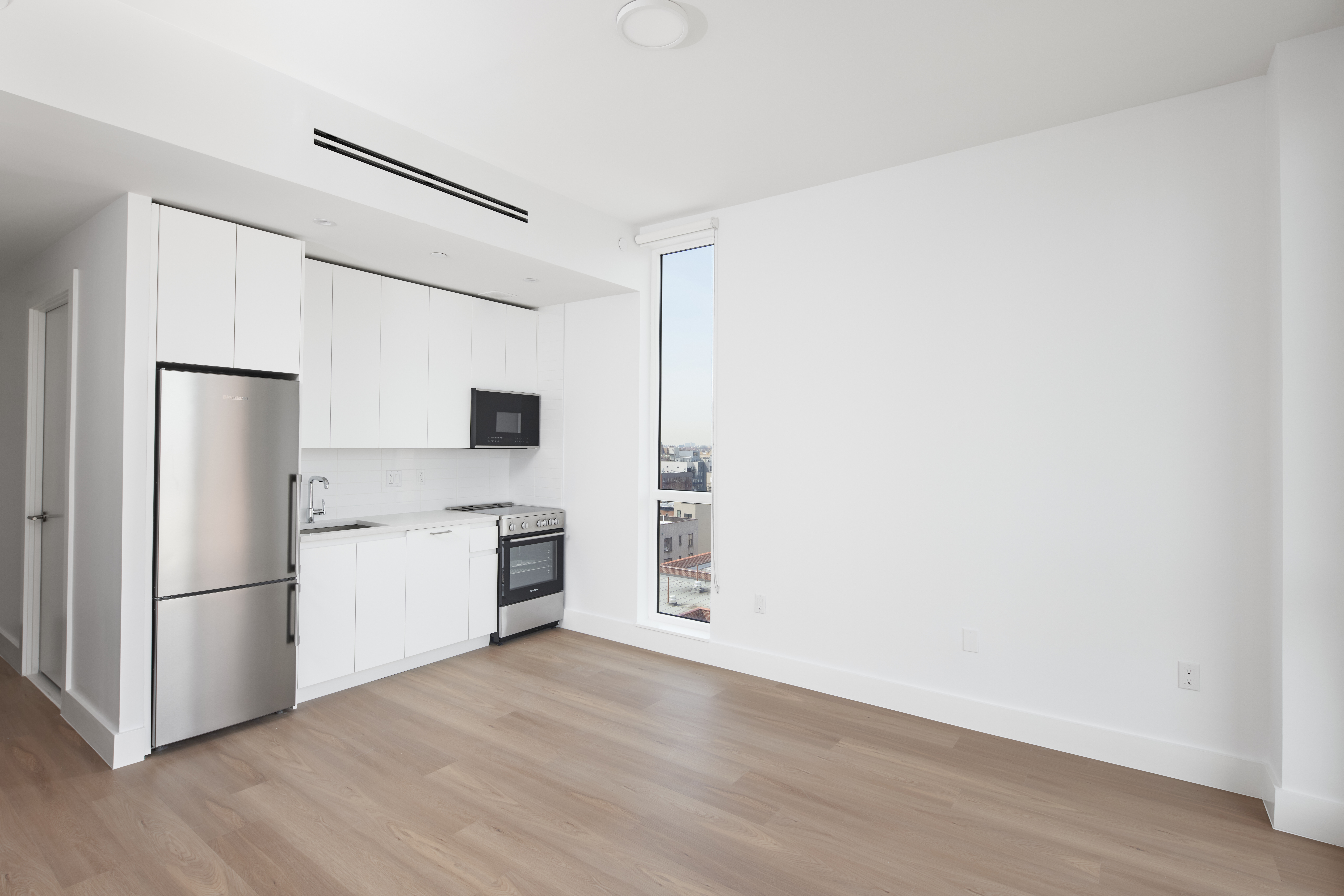 340 Lenox Road, Unit PHB Brooklyn, NY 11226 - Photo 5 of 26 a kitchen with a refrigerator cabinets and wooden floor