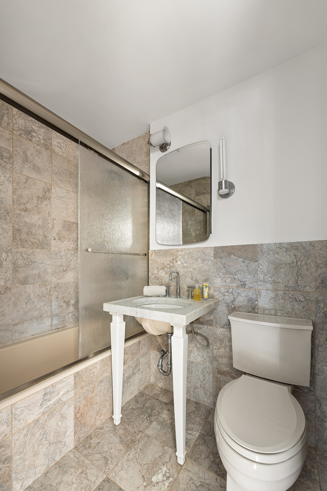 85 Livingston Street, Unit 6F Brooklyn, NY 11201 - Photo 9 of 11 a bathroom with a toilet a sink and mirror