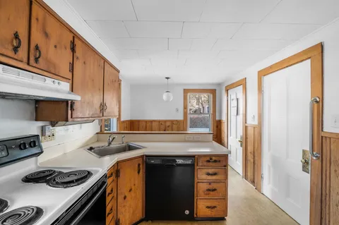 a kitchen with stainless steel appliances granite countertop a refrigerator a stove a sink dishwasher and a refrigerator