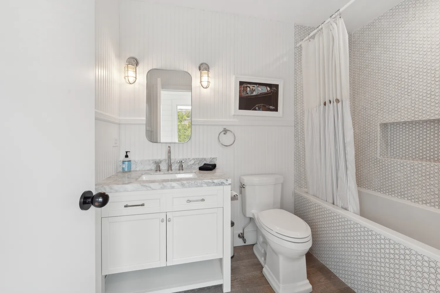 a bathroom with double vanity and a glass door shower