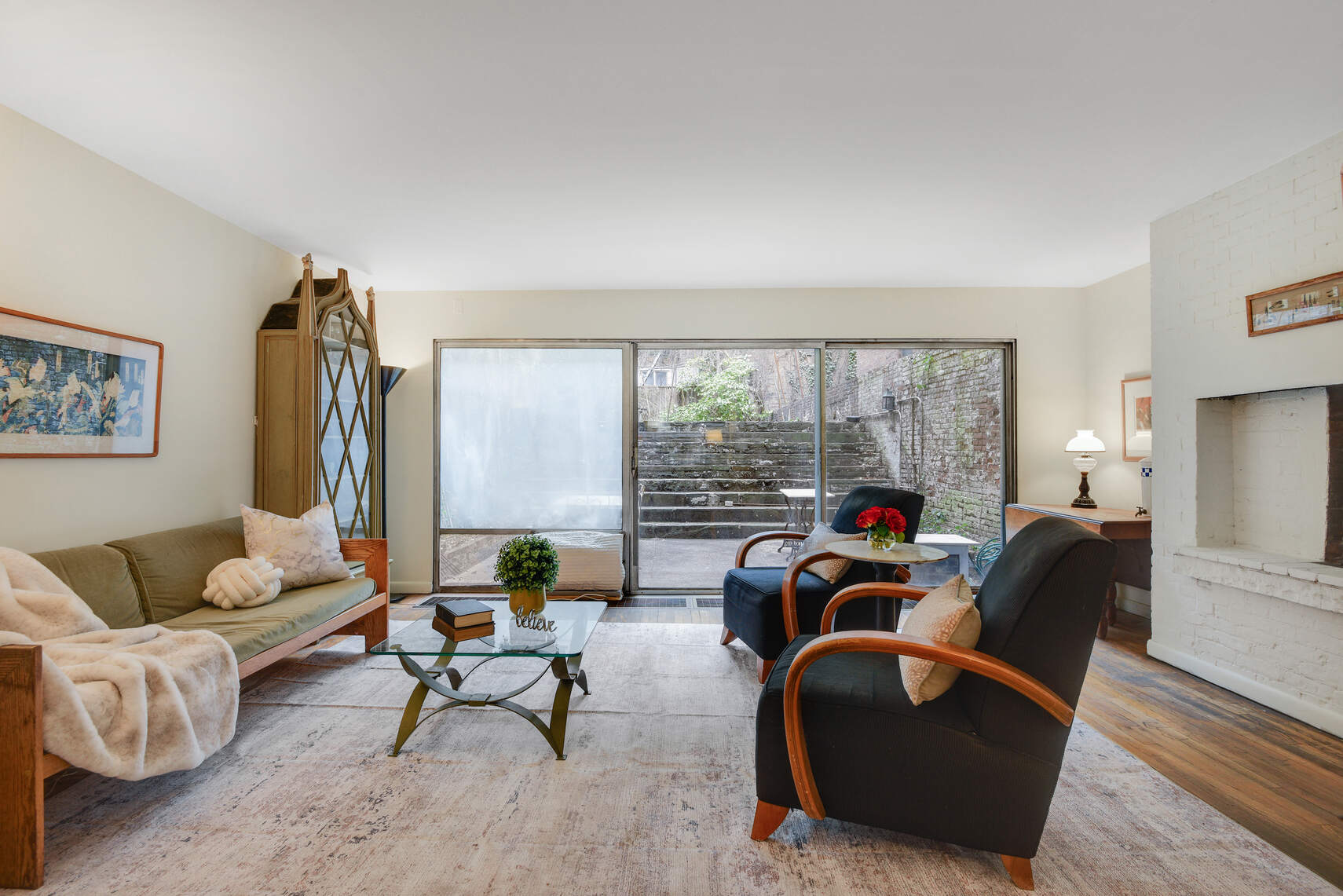 217 West 15th Street Manhattan, NY 10011 - Photo 3 of 21 a living room with furniture and a floor to ceiling window