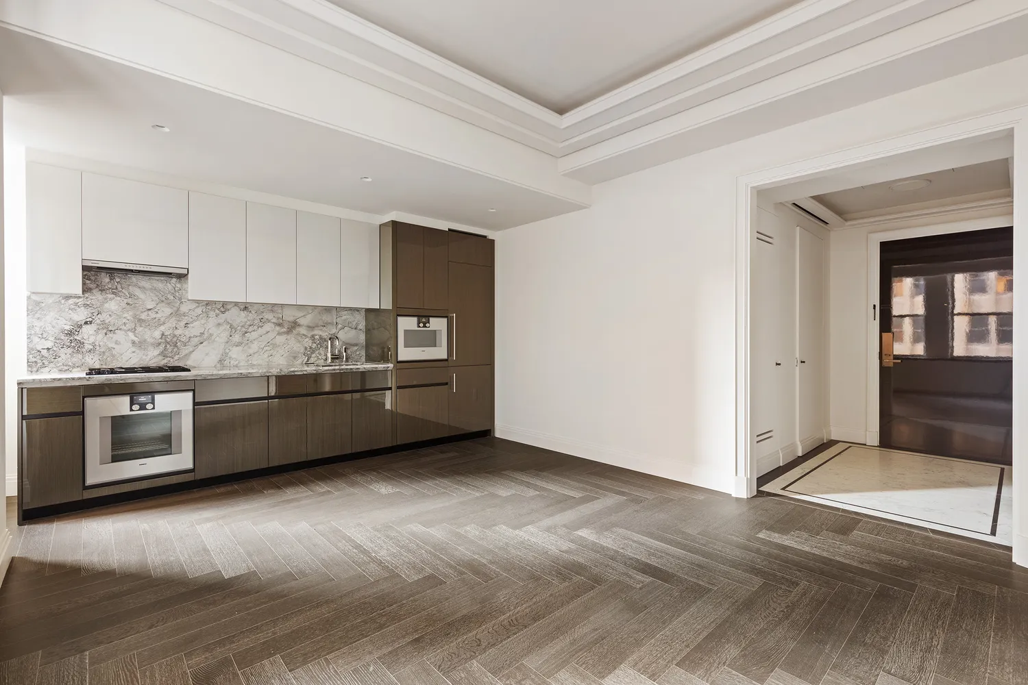 a kitchen with stainless steel appliances and a wooden floor