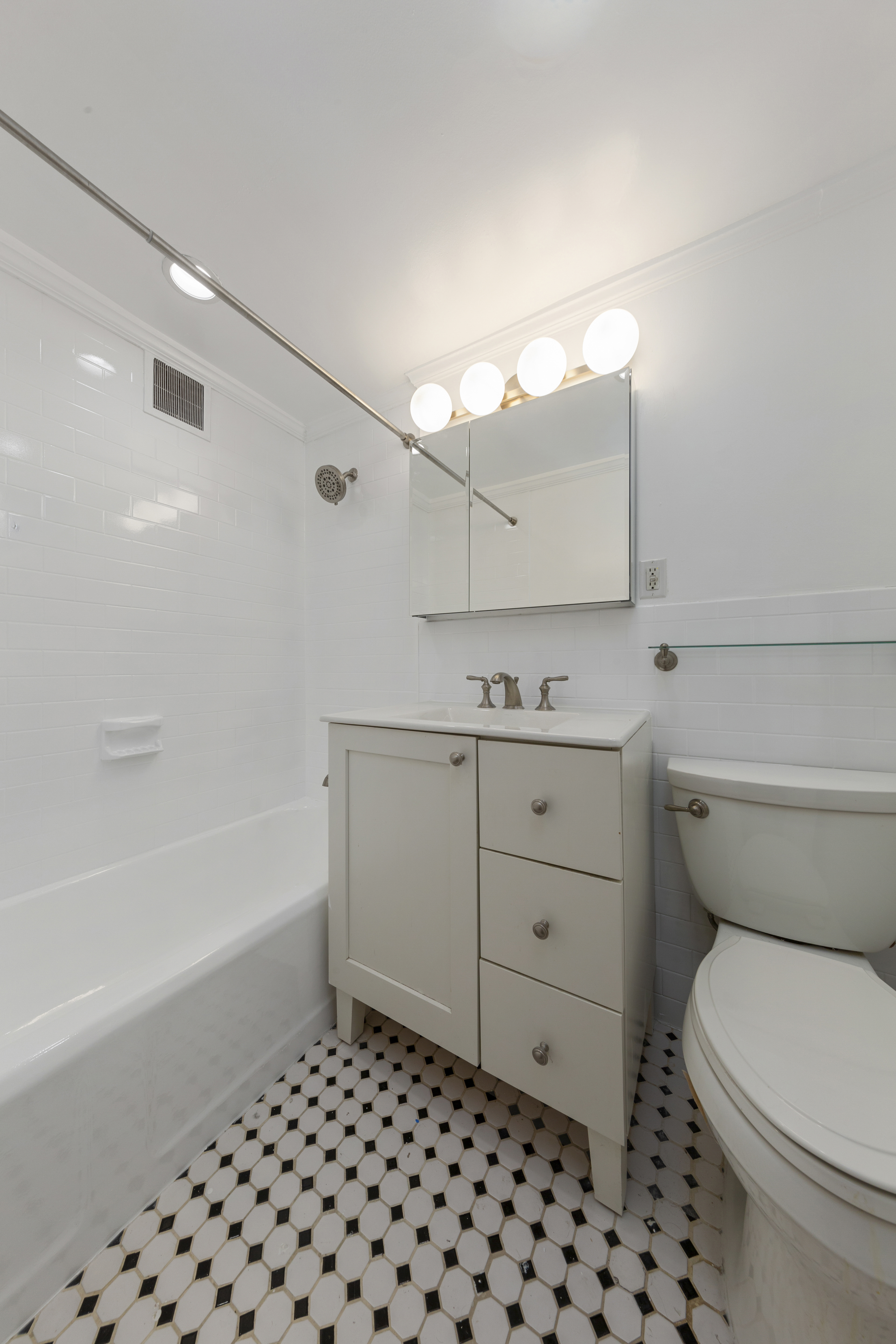 355 Clinton Avenue, Unit F1 Brooklyn, NY 11238 - Photo 9 of 20 a bathroom with a sink a toilet and bathtub