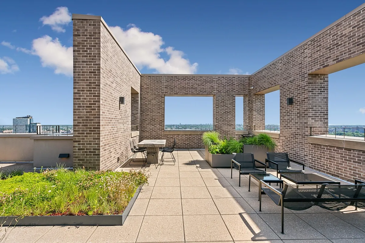 626 Flatbush Avenue, Unit 7E Brooklyn, NY 11225 - Photo 19 of 23 a view of a patio with couches table and chairs with potted plants