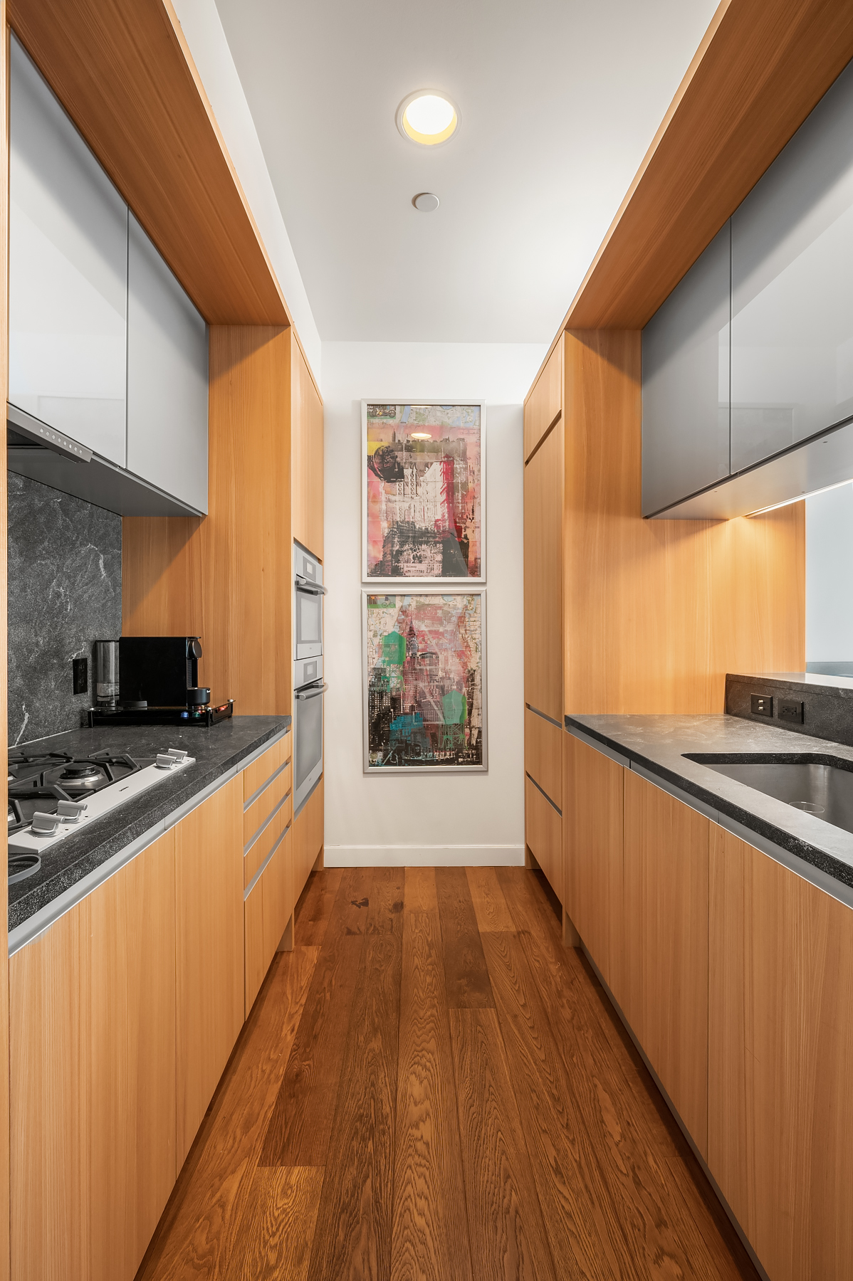 311 West Broadway, Unit 4G Manhattan, NY 10013 - Photo 2 of 8 a large kitchen with stainless steel appliances a large window a oven and a sink